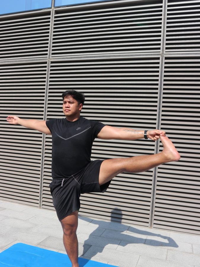 An ATHLI member holding a balance pose outdoors