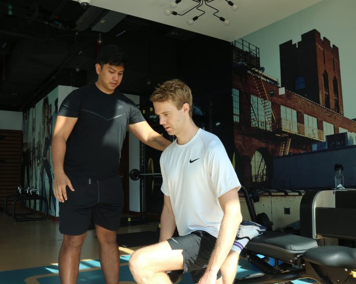 An ATHLI coach talking a member through their next step